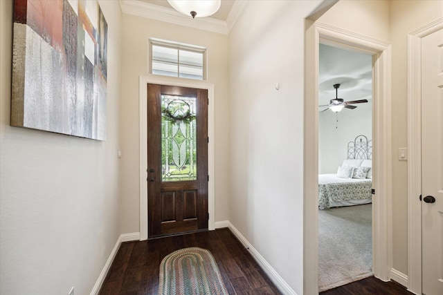 entrance foyer with ceiling fan, baseboards, ornamental molding, and dark wood finished floors