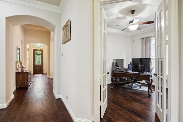 hallway with dark wood finished floors, arched walkways, crown molding, and french doors