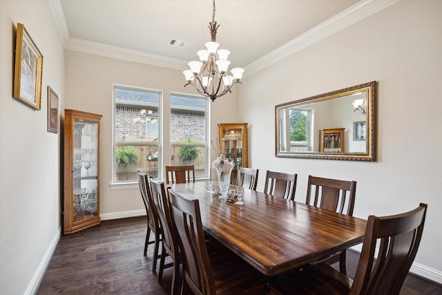 dining area with dark wood-style flooring, an inviting chandelier, baseboards, ornamental molding, and visible vents