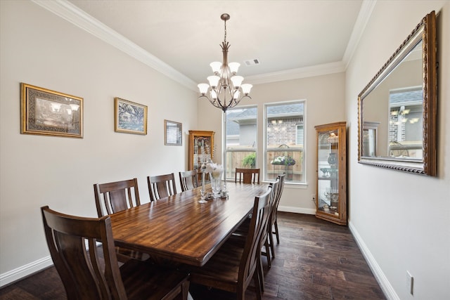 dining room featuring crown molding, dark hardwood / wood-style flooring, and a chandelier