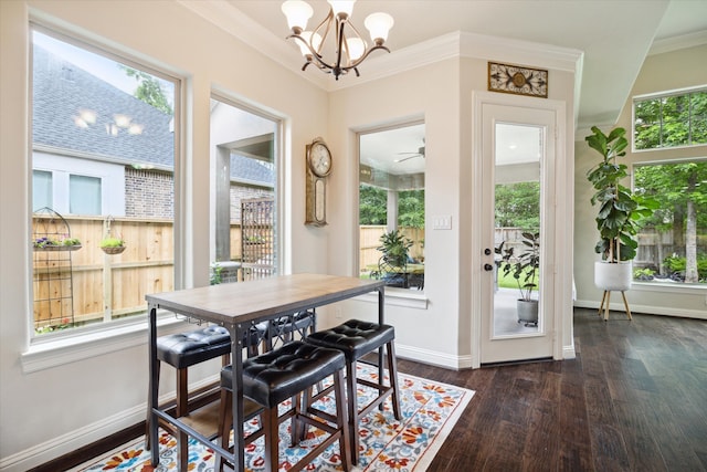 dining area with ceiling fan with notable chandelier, ornamental molding, and dark wood-type flooring