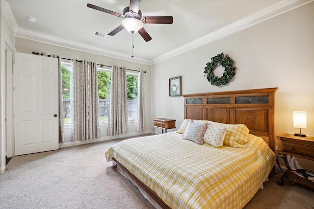 carpeted bedroom with ceiling fan, visible vents, baseboards, and ornamental molding