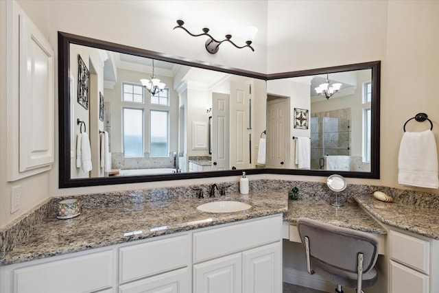 bathroom with vanity, a shower stall, a chandelier, and crown molding