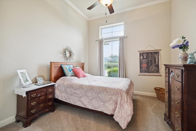 bedroom featuring baseboards, a ceiling fan, carpet flooring, and ornamental molding