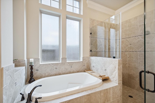 bathroom featuring a garden tub, a shower stall, and crown molding