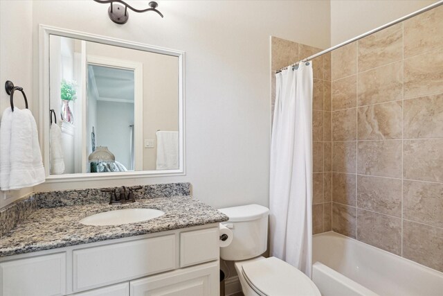 bathroom with shower / bath combination with curtain, toilet, and vanity
