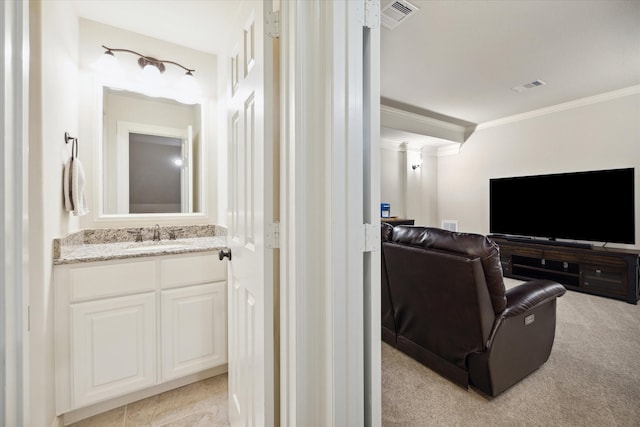 cinema room with light carpet, ornamental molding, and sink