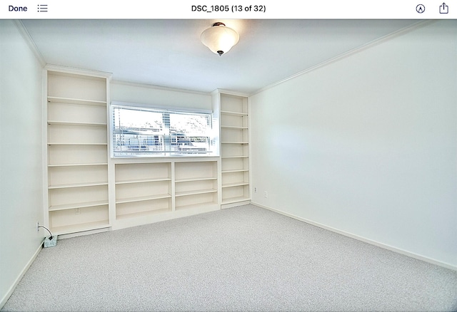 carpeted empty room with crown molding