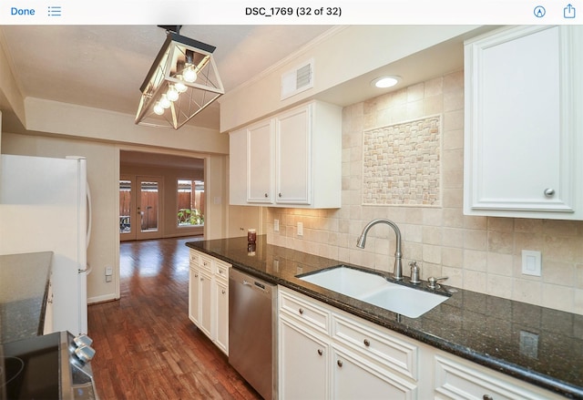 kitchen with white cabinetry, sink, pendant lighting, and stainless steel dishwasher