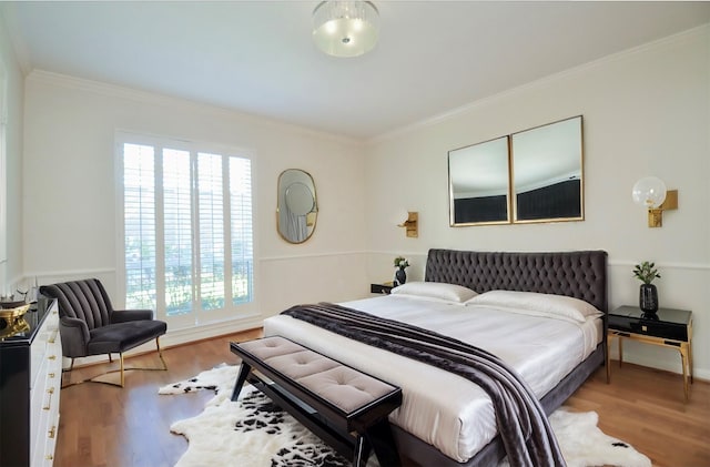 bedroom featuring hardwood / wood-style flooring and crown molding