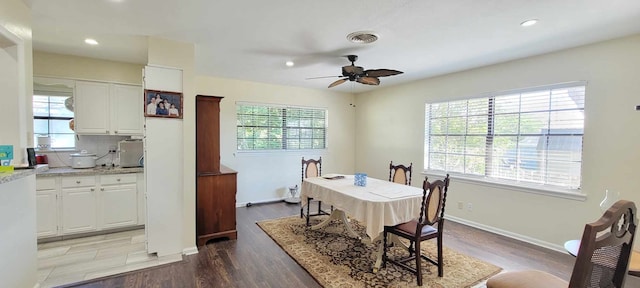 dining area with light hardwood / wood-style floors and ceiling fan