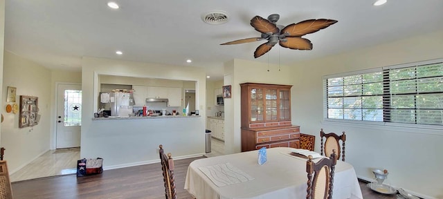 dining area with wood-type flooring and ceiling fan