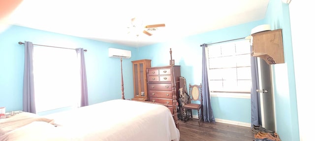 bedroom with ceiling fan, dark wood-type flooring, and a wall unit AC