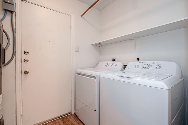 laundry area with washing machine and clothes dryer and wood-type flooring