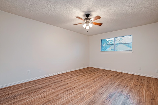 spare room with light hardwood / wood-style flooring, a textured ceiling, and ceiling fan