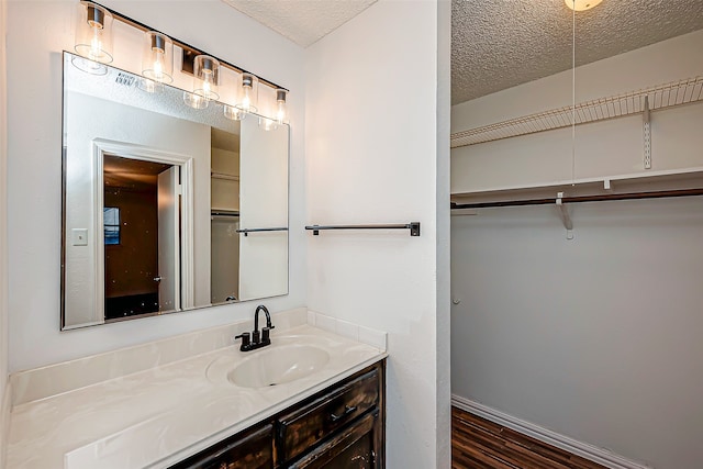 bathroom featuring vanity, a textured ceiling, and hardwood / wood-style flooring