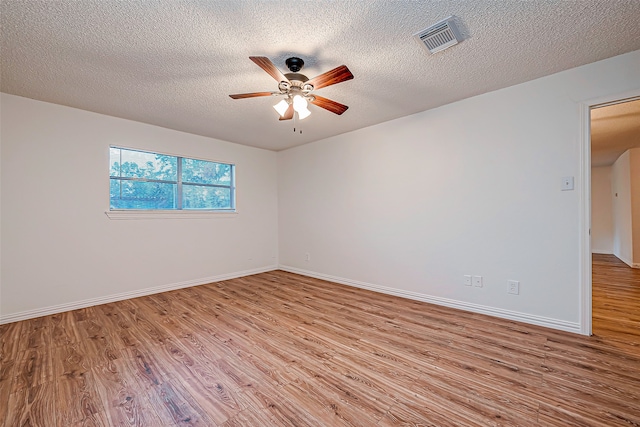 spare room featuring ceiling fan, a textured ceiling, and light hardwood / wood-style flooring