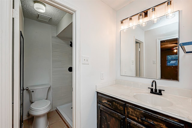 bathroom featuring toilet, tile patterned flooring, a shower, vanity, and a textured ceiling