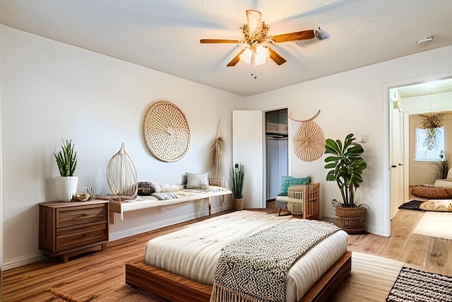 bedroom with ceiling fan and light hardwood / wood-style flooring