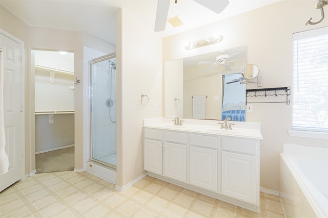 bathroom with vanity, a healthy amount of sunlight, and separate shower and tub