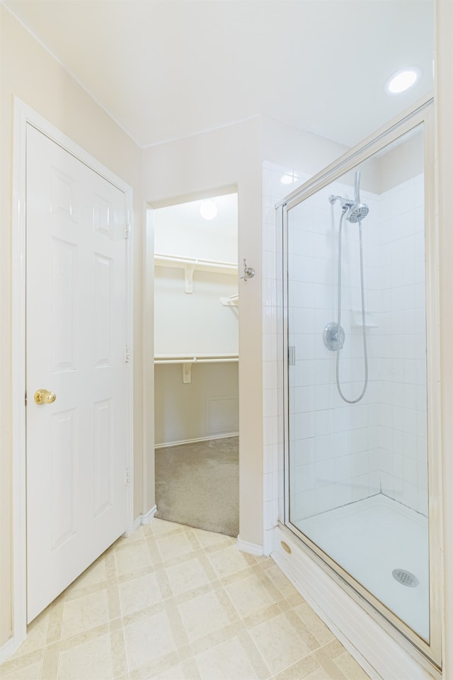 bathroom with a shower with shower door