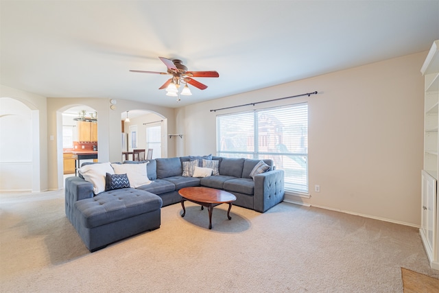 carpeted living room featuring ceiling fan