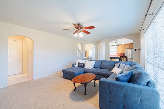 carpeted living room with ceiling fan