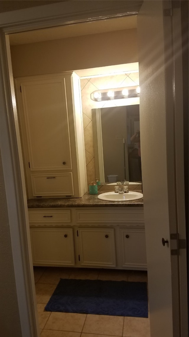 bathroom with tile patterned flooring and vanity