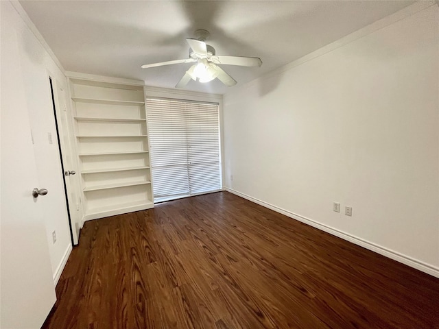 unfurnished bedroom featuring dark wood-style floors, baseboards, and ceiling fan