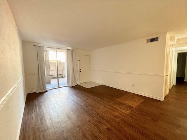 empty room with visible vents and dark wood-style floors