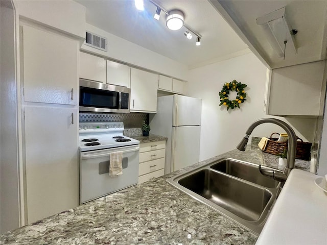 kitchen featuring track lighting, white appliances, white cabinets, visible vents, and a sink