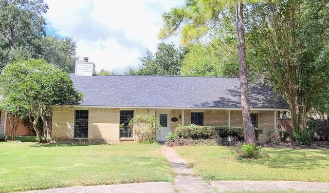 8 Abalone St, Bay City, TX 77414 - ranch-style home with brick siding, a chimney, and roof with shingles