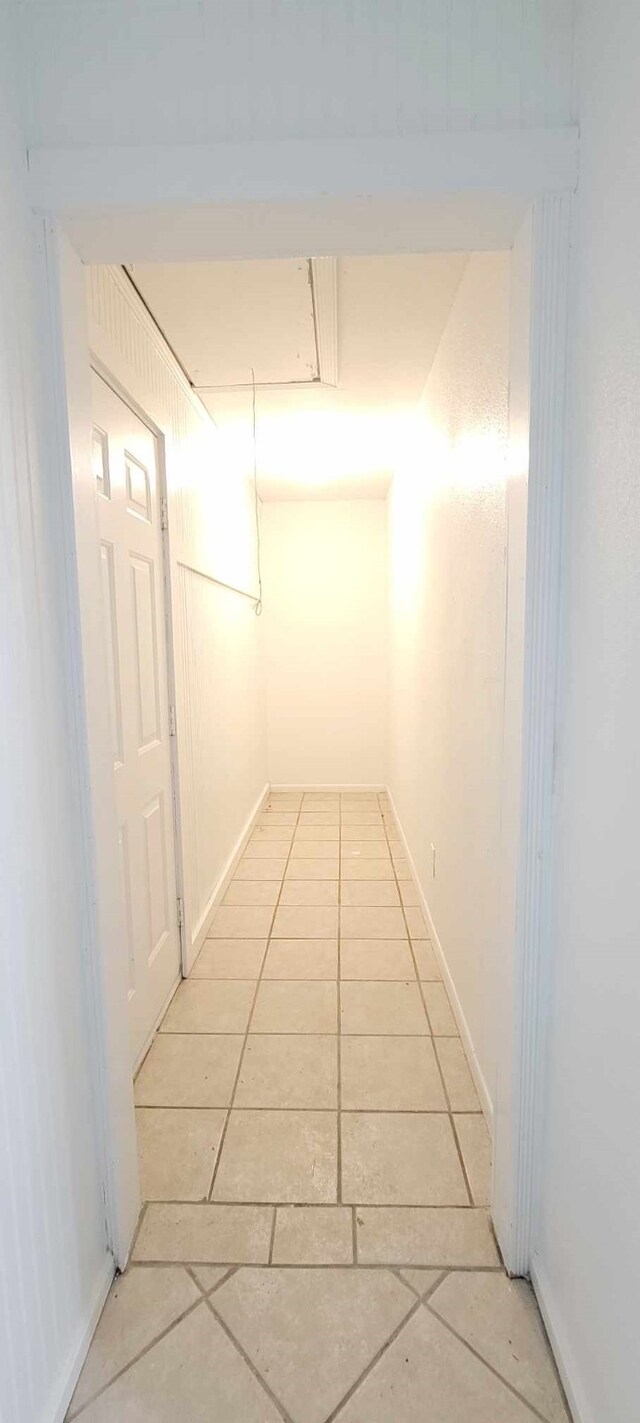 corridor with light tile patterned flooring