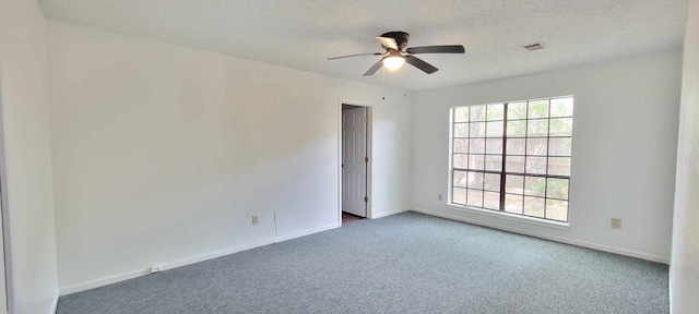 unfurnished room featuring ceiling fan, a textured ceiling, and carpet