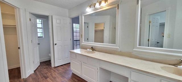 bathroom with vanity, hardwood / wood-style floors, toilet, and a textured ceiling