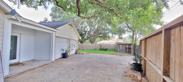 8 Abalone St, Bay City, TX 77414 - view of patio featuring a detached garage and a fenced backyard