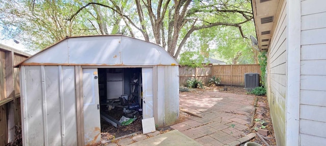 view of patio with a storage shed and central AC