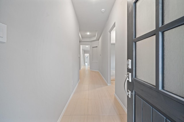 hall with recessed lighting, tile patterned flooring, and baseboards