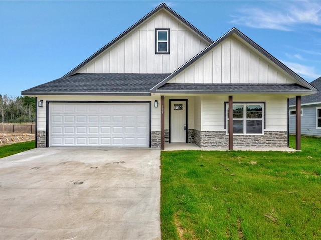 view of front of home featuring a garage, a shingled roof, concrete driveway, stone siding, and a front lawn