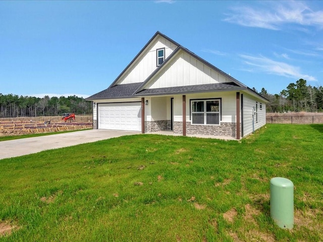 view of front facade featuring an attached garage, board and batten siding, a front yard, fence, and driveway