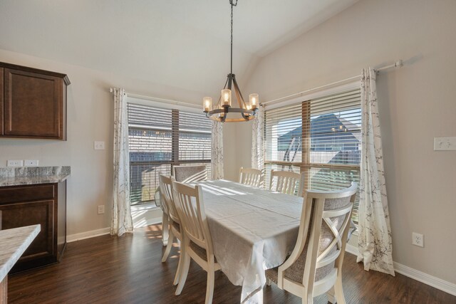 dining area with vaulted ceiling, dark hardwood / wood-style floors, plenty of natural light, and a chandelier