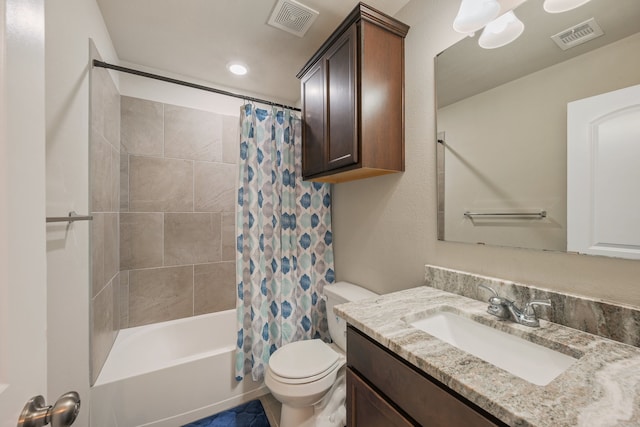 full bathroom featuring vanity, shower / bath combo with shower curtain, and toilet