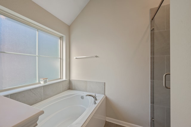 bathroom with independent shower and bath and lofted ceiling