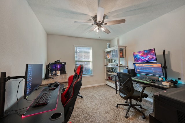 carpeted office space featuring ceiling fan and a textured ceiling