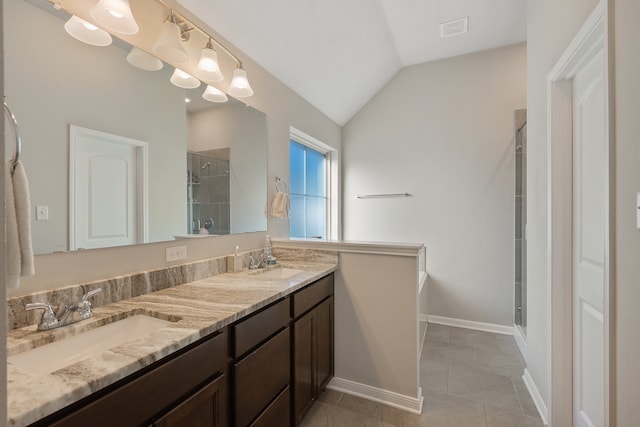 bathroom with tile patterned flooring, vanity, vaulted ceiling, and an enclosed shower