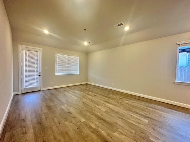 unfurnished room with light hardwood / wood-style floors