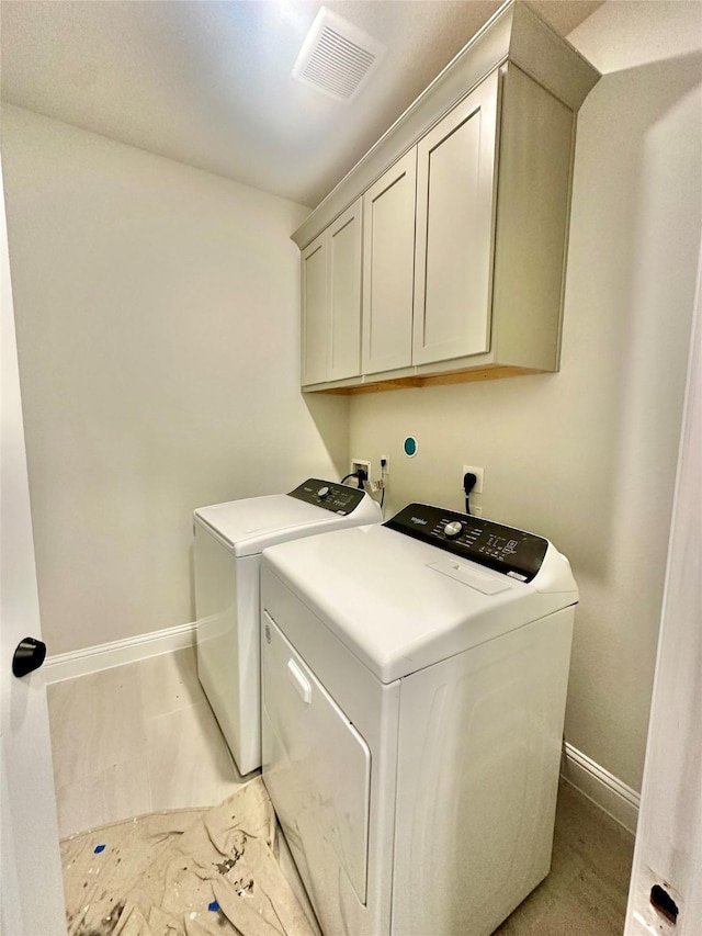 laundry area with cabinets and washer and dryer