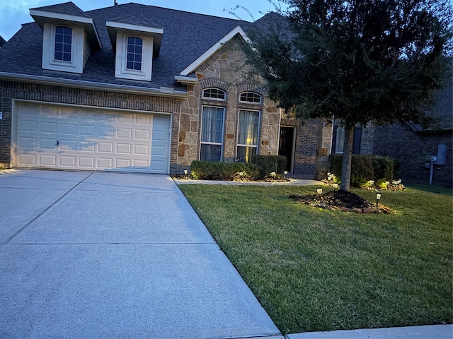 331 W Bend Dr, League City, TX 77573 - view of front facade with driveway, a garage, stone siding, a front lawn, and a shingled roof