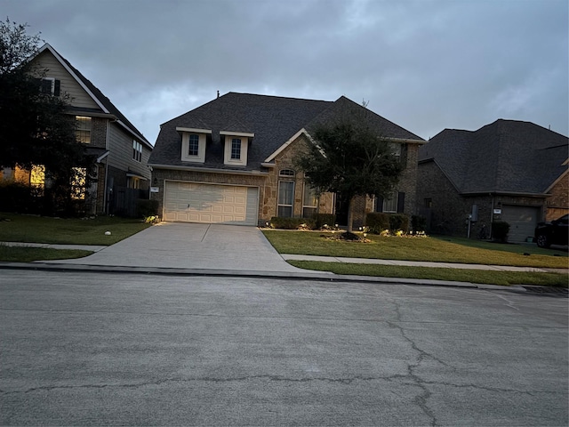 331 W Bend Dr, League City, TX 77573 - view of front of property featuring driveway, a front yard, stone siding, and an attached garage