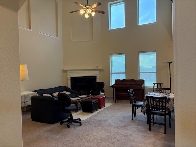 331 W Bend Dr, League City, TX 77573 - carpeted living area with a towering ceiling, ceiling fan, healthy amount of natural light, and a fireplace
